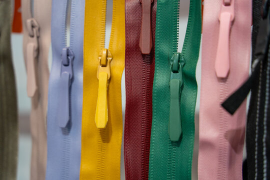 Colorful assorted zippers in various vibrant hues arranged neatly