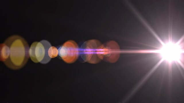 Cinematic light flare transitions with bokeh and lens effects during a digital zoom on black