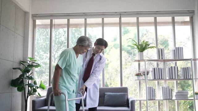Doctor helping senior woman walk with mobility walker in care home