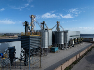 industrial metal silos under blue sky © zhu difeng
