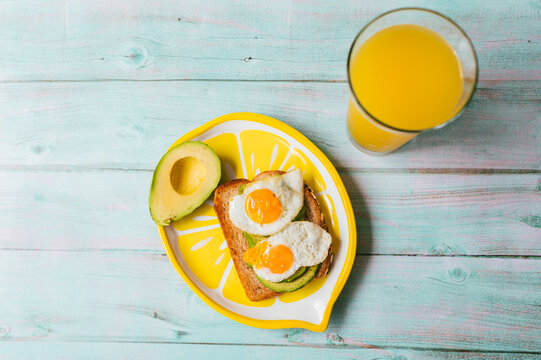 Healthy breakfast with avocado toast and quail eggs
