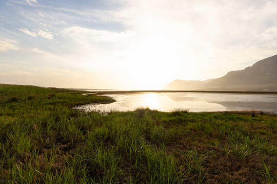 pastel sunset over placid lagoon and Klein Mountain reflection, Stanford, South Africa