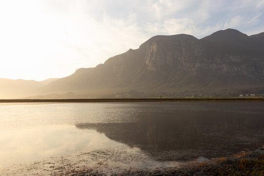 pastel sunset over placid lagoon and Klein Mountain reflection, Stanford, South Africa