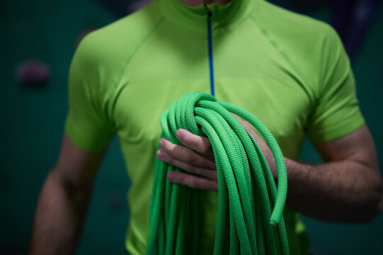 Close up of boulderer holding climbing rope.