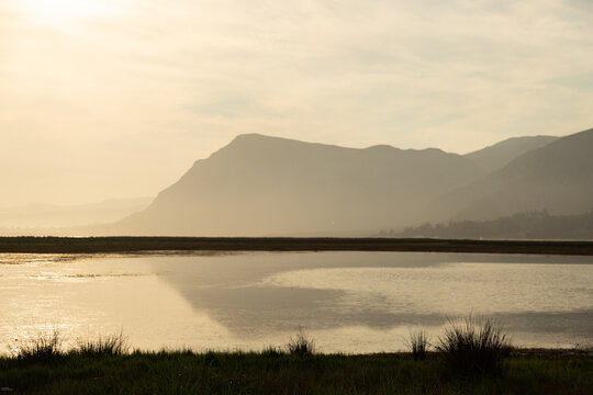 pastel sunset over placid lagoon and Klein Mountain reflection, Stanford, South Africa