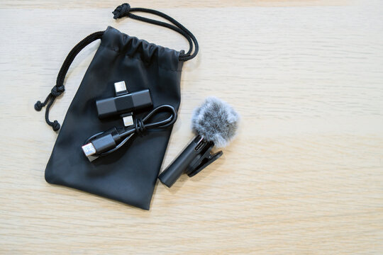 Small wireless lavalier microphone with furry windshield and accessories