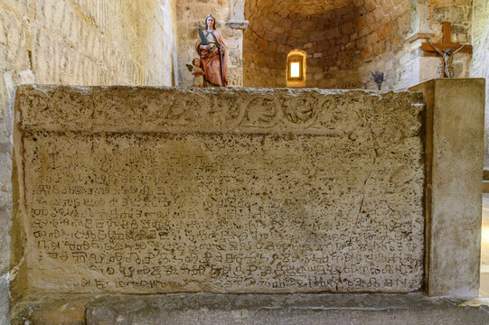 Close-up of the Ba&scaron;ka tablet replica, medieval Glagolitic inscription carved in stone with a vine frieze, Jurandvor, Krk island, Croatia