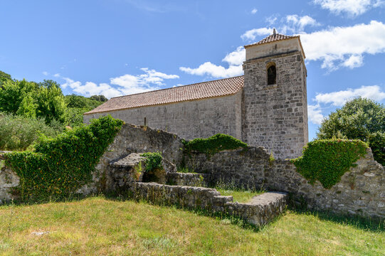 Bell tower of St Lucia church rising above ivy-covered monastery ruin walls in a meadow, Jurandvor, Ba&scaron;ka, Krk island, Croatia