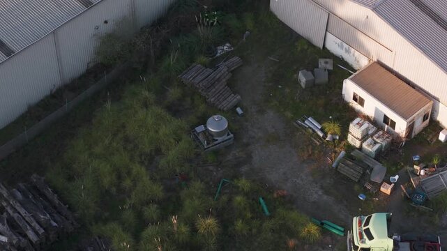 Aerial view of abandoned industrial backyard with truck