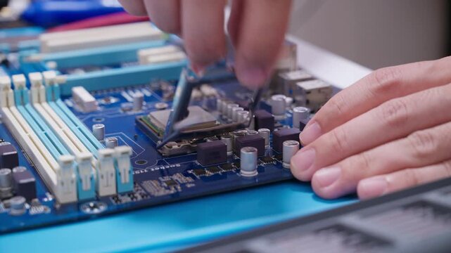 hand installing a central processing unit CPU microprocessor chip into computer motherboard socket as a conceptual metaphor for AI hardware technology computer engineering data 