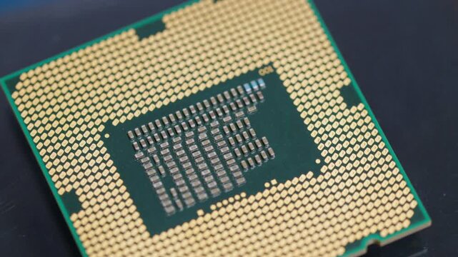 CPU computer microprocessor chip showing golden pins and capacitors on a blue background as a conceptual backdrop for artificial intelligence hardware semiconductor innovation cloud computing and info