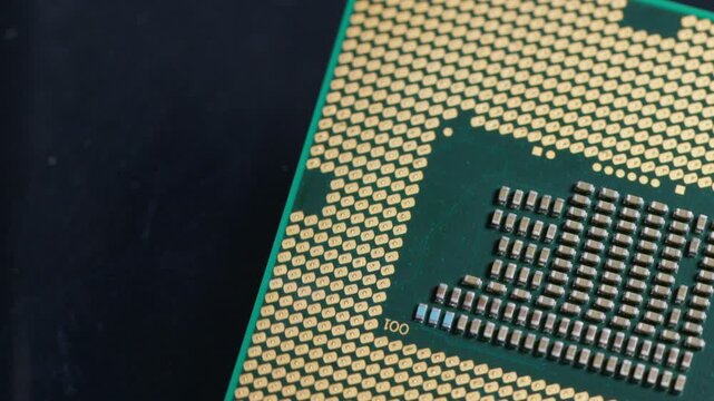 CPU computer microprocessor chip showing golden pins and capacitors on a blue background as a conceptual backdrop for artificial intelligence hardware semiconductor innovation cloud computing and info