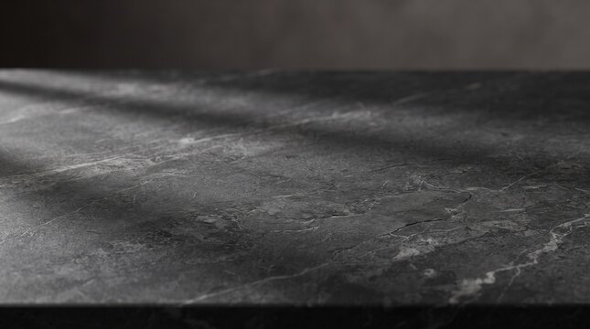 Dark gray stone surface with fine texture. Ideal for product photography backgrounds and modern design projects.