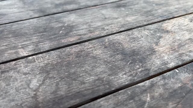 Close up of rustic grey timber flooring backdrop with natural cracks