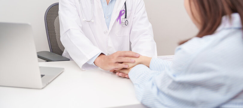 doctor holding patient hand to comfort and support with empathy. purple ribbon for concept of Violence, Pancreatic, Esophageal, Testicular cancer, Alzheimer, Epilepsy, Lupus and Fibromyalgia