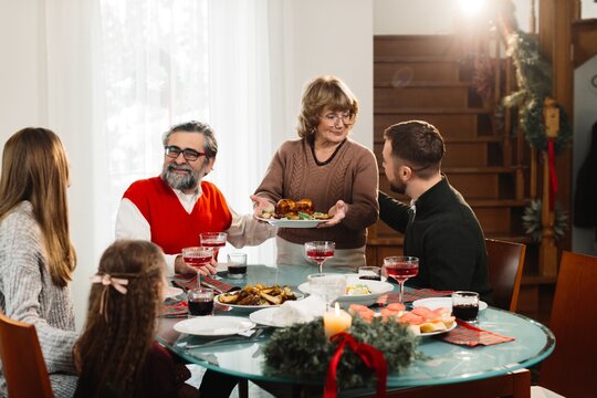 Multi-generational family celebrating christmas dinner at home