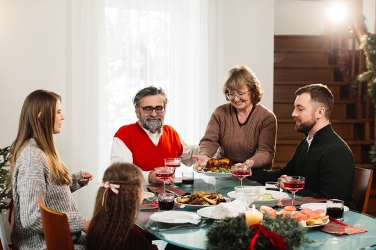 Multi-generational family celebrating christmas dinner at home