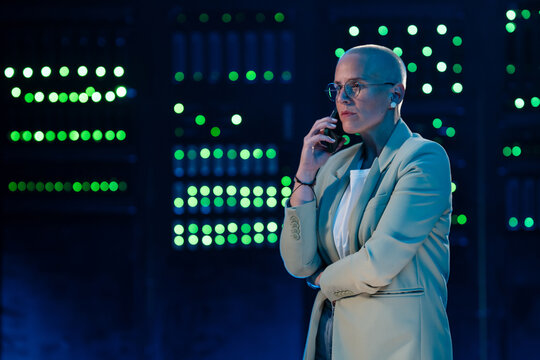 Female it professional solving issues on phone in data center