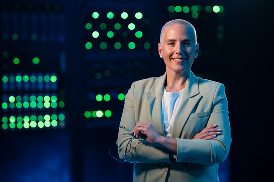 Confident woman working in server room managing technology