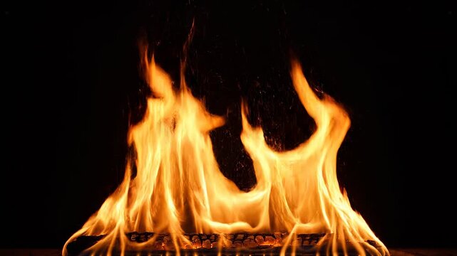 Fiery flames dancing with intense heat against a dark backdrop for energetic concepts