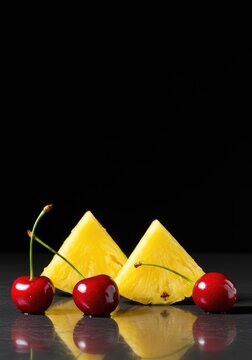 Bright, tropical image featuring sweet red cherries and vibrant yellow pineapple slices, perfect for summer drinks and desserts ,ripe ,whole fruit ,vibrant