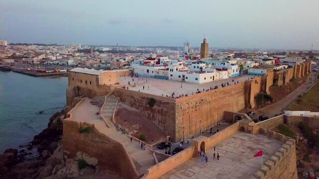 Drone rises and pulls away from Rabat's Kasbah of the Udayas above the coast.