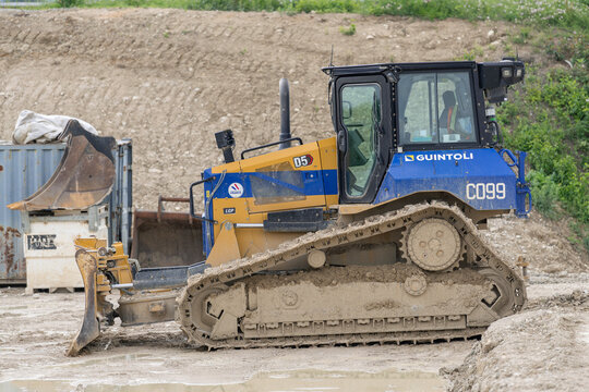 Ligny-en-Barrois, France - June 9th 2025 : View on a yellow and blue bulldozer CAT D5 for earthworks on a construction site.