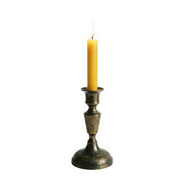 Lit yellow candle in an ornate vintage brass candlestick holder isolated on transparent background