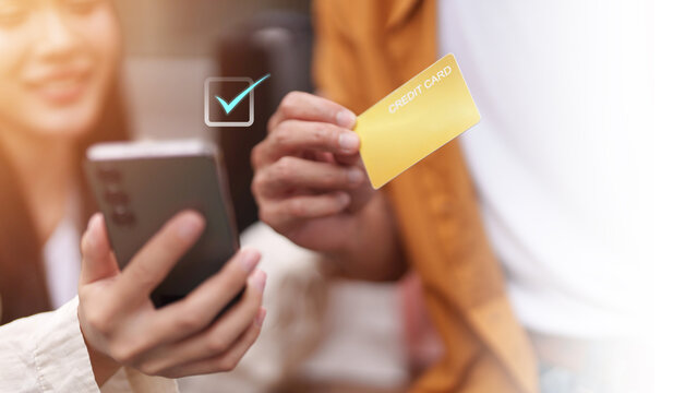 Asian woman making online mobile payment with credit card on smartphone