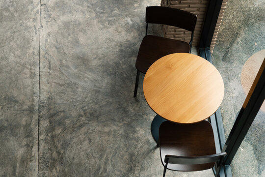 top view of two chairs and wood table  in cafe on the concrete floor