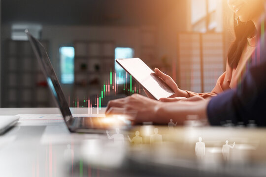 Business team using laptop and digital tablet for financial market analysis