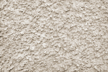 Coarse aggregate rough plaster texture background with pebble dash grain effect for modern architectural wall facade finish concept © Sergio Grisaldi