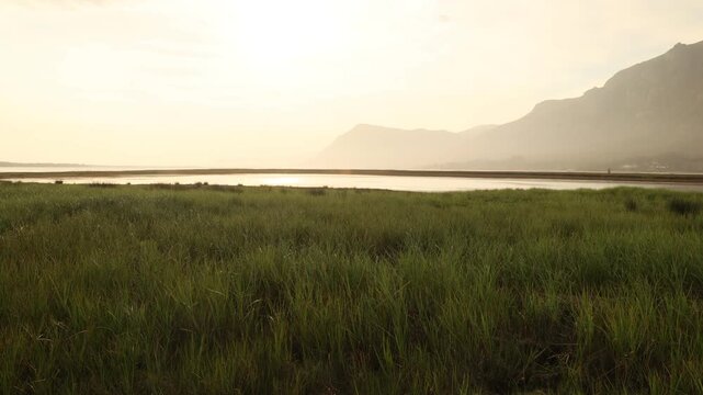 pale sunset over Lagoon and reflection of Klein Mountains, Stanford, South Africa