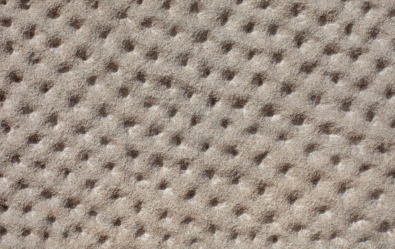 Handcrafted dimpled stone plaster texture background with decorative pitted pattern for modern architectural and interior design concept