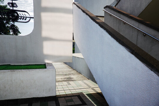 Modern concrete staircase under concrete structures and bright shadows on sunny day
