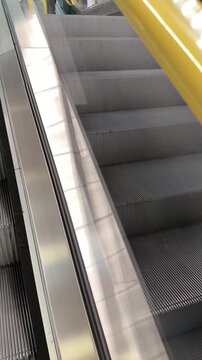 Helsinki library: Close Detail of a Yellow Escalator Handrail in Motion