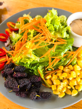 Caesar Salad has many vegetables inside. Sprinkle with cheese and dressing.