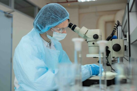 Science, microscope and innovation with a woman in a laboratory for medical research or experiment. Healthcare, medicine and a young indian engineer working in a lab for pharmaceutical development