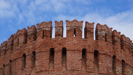 Battlements of an red brick fortress tower © Avo_Fox