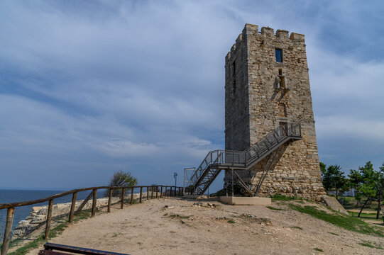 Byzantine tower of Nea Fokea with its metal access staircase, a wooden fence and the sea from the headland plateau, Kassandra, Chalkidiki, Greece