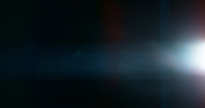 Anamorphic lens flare and light leak effect on dark background. Minimal cinematic optical texture ideal for overlays, film production, motion graphics and visual effects.