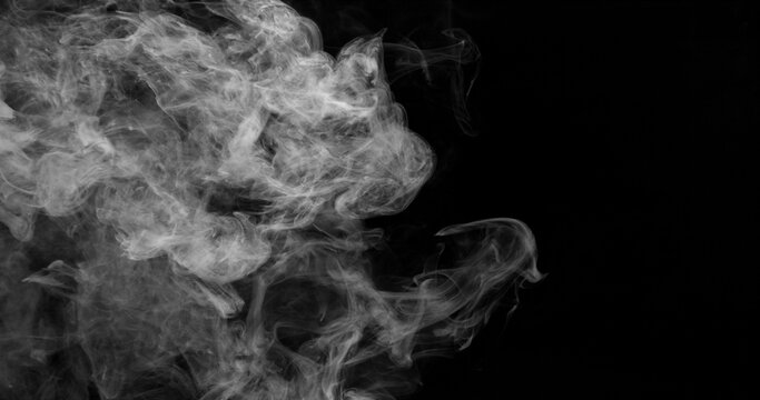Delicate white smoke wisps drifting across a dark background. Atmospheric abstract texture with soft swirling patterns, ideal for creative design, overlays and visual effects projects.