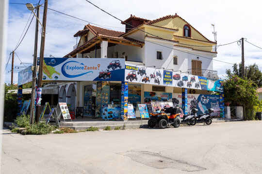 Laganas, Greece, 9th September 2026: Explore Zante vehicle and excursion rental shop in Laganas with quad bikes scooters and colourful advertising signs outside the premises