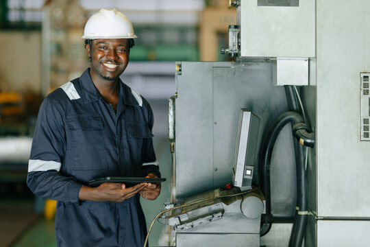 Portrait Happy Smiling Black Engineer Operating CNC Machine in Metal Part Industry Factory