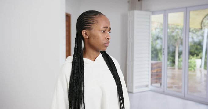 High speed photography for dynamic scenes, standing indoors, woman with braided hair looking concern
