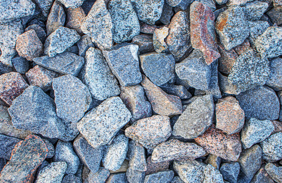Background stone,coarse grey crushed granite gravel and ballast stone texture