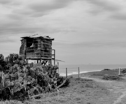 Rustic wooden lifeguard hut on a beach, black and white fine art photography 
