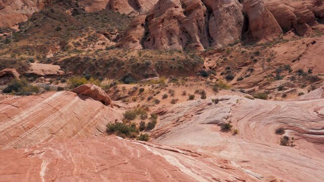 Panoramic view of the colorful red sandstone formations and unique geology of the fire wave trail, an iconic landmark in nevada's valley of fire state park, during a sunny day