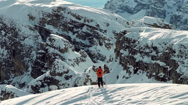 Beautiful Winter Dolomite Mountain Scenery with Man on Cross-Country Skis , Aerial View