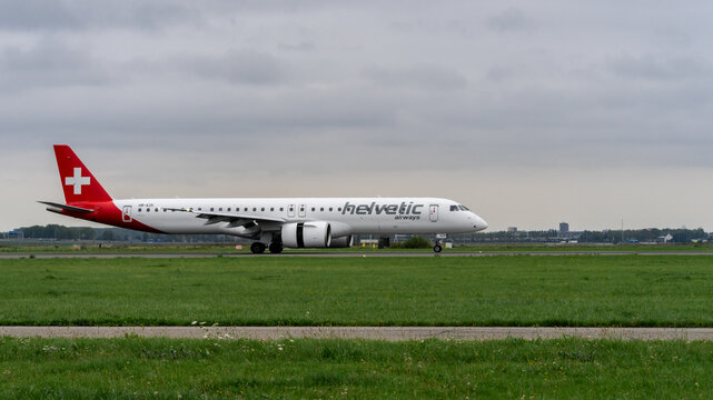 helvetic airways airplane landing at Schiphol Airport. Amsterdam, The Netherlands.